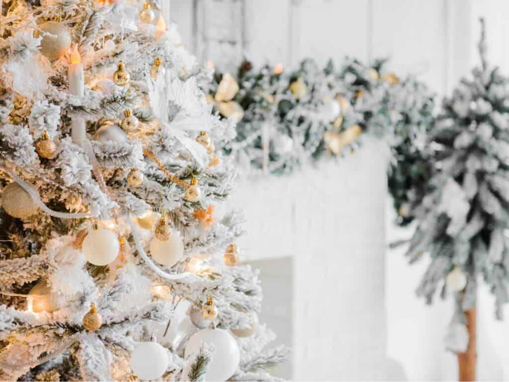 A beautifully decorated Airbnb living room featuring budget-friendly holiday decor, including twinkle lights, a small Christmas tree, and cozy blankets, creating a festive and welcoming space for guests.