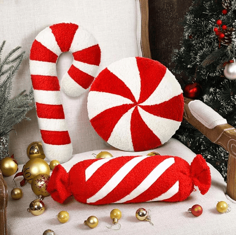 Candy cane and peppermint holiday pillow on soft airbnb sofa.