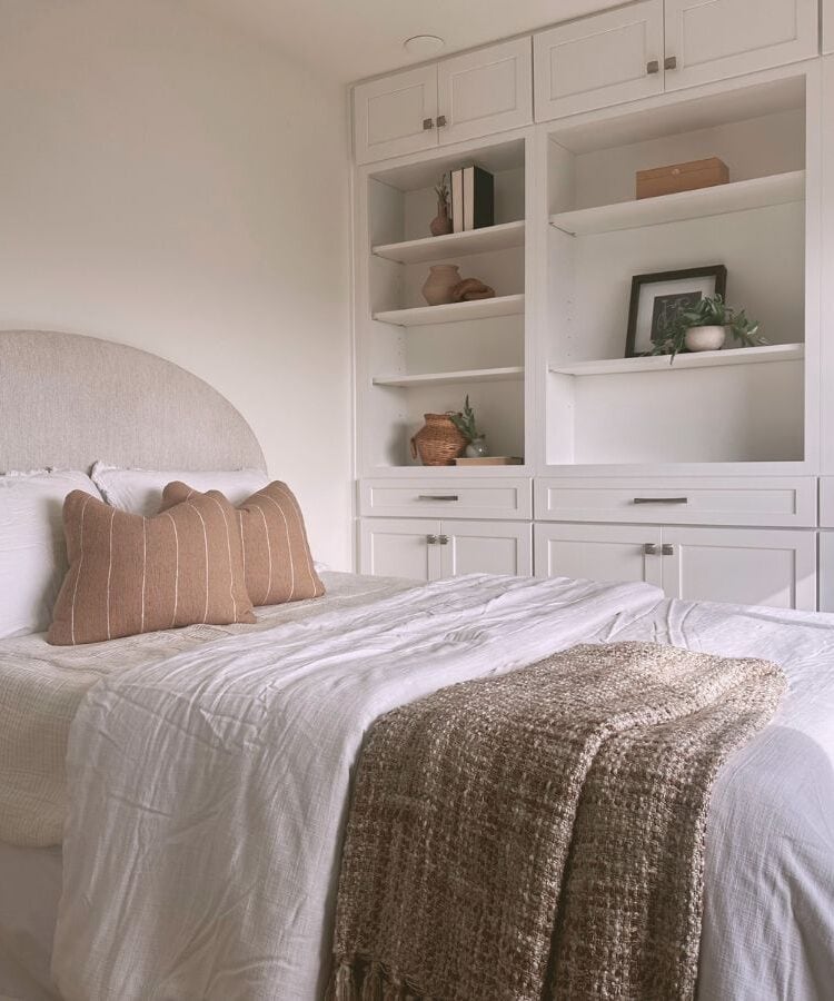 Compact Airbnb bedroom with creative storage solutions and cozy decor.